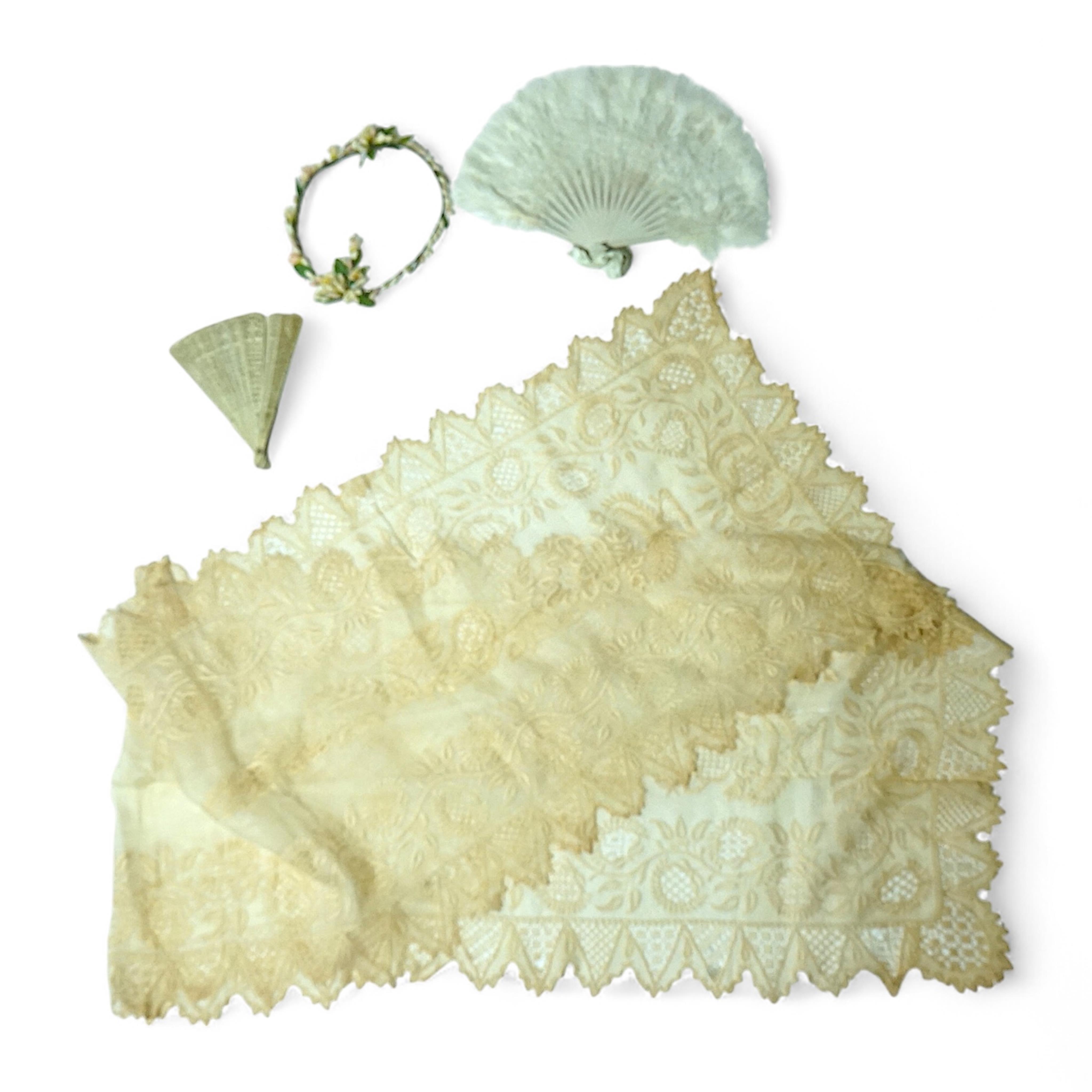 A 1920’s wax wedding headdress, a white feather fan, a bone brise and an earlier long lawn embroidered and lace worked stole., Stole 194cm long. Condition - headdress and fan good, stole has moth holes in places but can